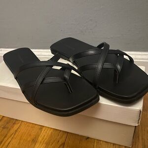 Black leather sandals with straps.
